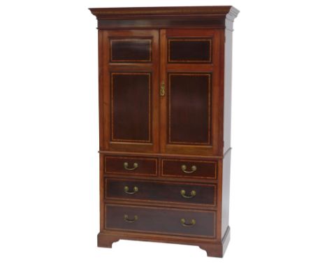 A late 19th/early 20thC mahogany and satinwood cross banded linen press, the top with a moulded edge above two panelled doors