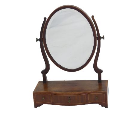 A Victorian mahogany and cross banded swing frame mirror, the oval mirror on scrolling supports, on a serpentine fronted base