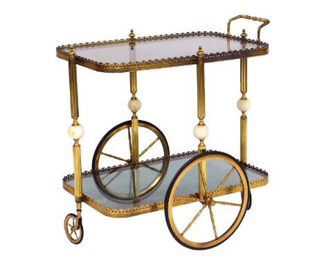 A mid century two tier brass framed drinks trolley, with two glass shelves, each shelf united by a reeded brass column with c