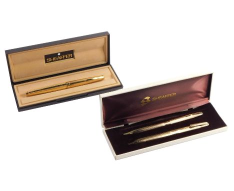 A Sheaffer fountain pen, in gold coloured part engine turned casing, 14ct nib, boxed, together with a Sheaffer ball point and
