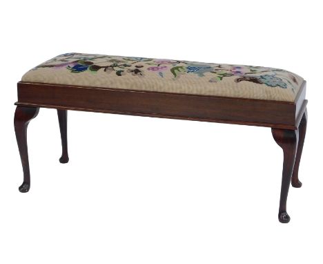 An early 20thC mahogany duet stool, the top with a floral tapestry seat, on cabriole legs with pad feet, 43cm high, 93cm wide
