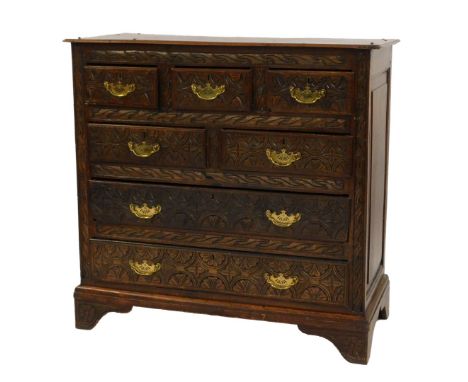 A 19thC oak chest, the front with three short above three long drawers, later carved, on bracket feet, 102cm high, 106cm wide
