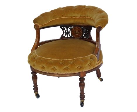 A Victorian rosewood and marquetry nursing chair, with button upholstered overstuffed back, above a pierced and ivory inlaid 