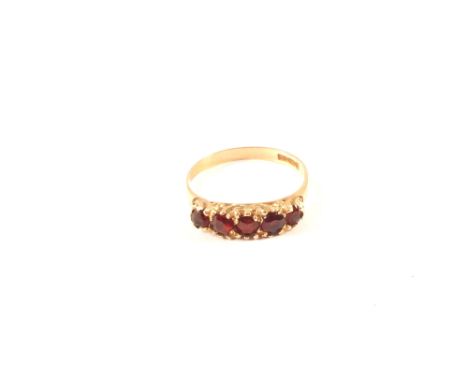 A 9ct gold ring set with five garnets, size K