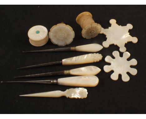 Mother of pearl needlework tools, two thread winders, two waxers, three stilettos, two fine hooks and a spool holder