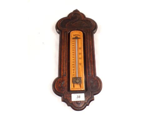 An oak cased fahrenheit thermometer with swan decoration