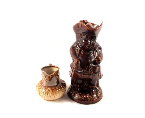 A 19th Century treacle glaze Toby jug and cover plus a 19th Century stoneware jug with hunting scenes