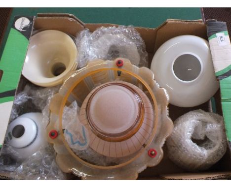 A box of various glass lamp shades