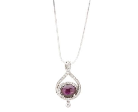 A star-ruby and diamond set pendantclaw set with an oval star-ruby cabochon in a scrolling border of round brilliant cut diam