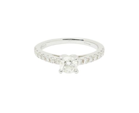 A single stone diamond ringclaw set with a round brilliant cut diamond, each shoulder set with seven smaller round cut diamon