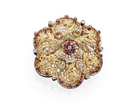 A ruby and diamond set broochof pierced foliate design, the central cluster claw set with a round brilliant cut diamond in a 