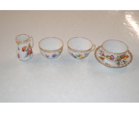 A collection of Dresden porcelain to include two cups, one saucer a cream, jug and sugar bowl
