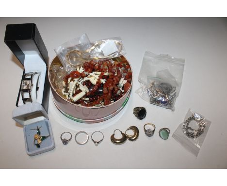 A tin of vintage costume jewellery to include Napier, Miracle, Trifan and a Gossip wrist watch