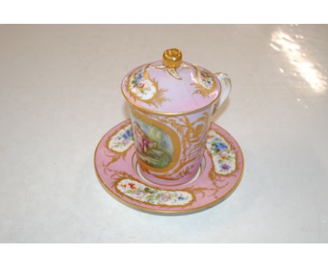 A Dresden covered cup and saucer, decorated with panel of courting couple on pink ground 