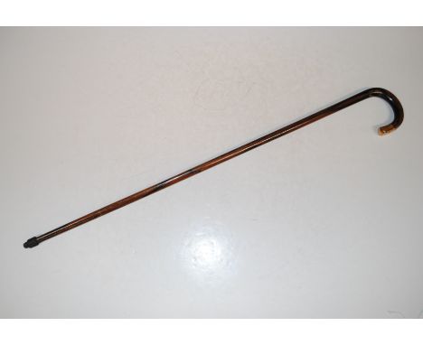 A 9ct gold capped walking stick engraved 'Presented to H.W. Woodford Esq. The Staff Of the R.B.S. August 1919'