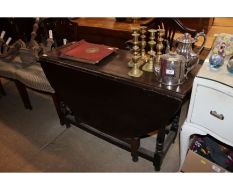 An antique oak gate leg table 