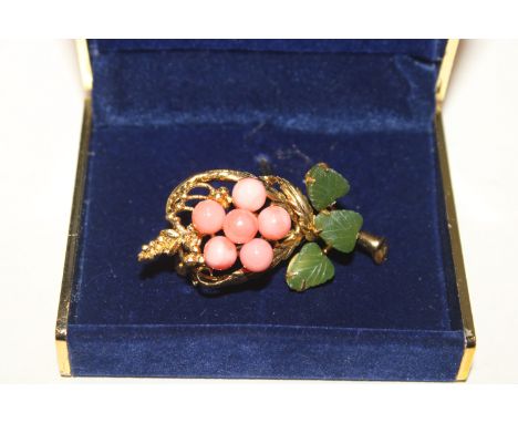 A coral and jade brooch on gold tone metal 
