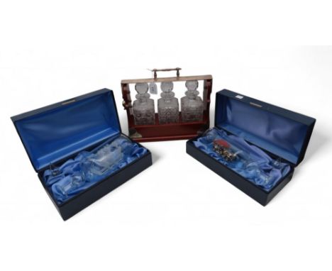 A three bottle tantalus, together with a glass ship in a bottle and a toy car in a glass bottle Condition Report:Available up