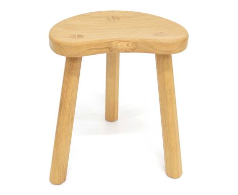 A Workshop of Robert Thompson "Mouseman" Oak Cow Stool. Kidney shaped seat on three octagonal legs, with carved mouse motif o