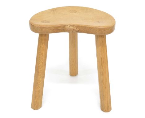 A Workshop of Robert Thompson "Mouseman" Oak Cow Stool. Kidney shaped seat on three octagonal legs, with carved mouse motif o