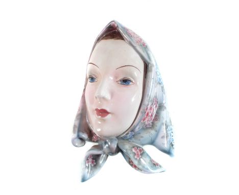 Goldscheider mask of a lady, wearing a floral bonnet, impressed and printed marks to reverse.24cm high Condition report: Rest