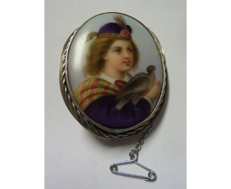 Late Victorian oval brooch with porcelain plate depicting head and shoulder portrait of a young Scottish gentleman with bird 