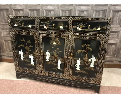 MID 20TH CENTURY CHINESE SIDEBOARDwith three short drawers over three cupboard doors, with figures in relief partly in mother