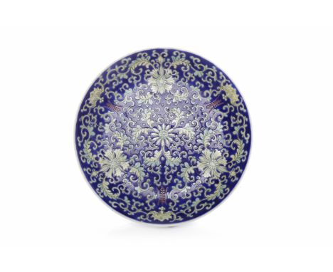 CHINESE CHING DYNASTY PLATE the interior decorated with florals and bats in enamel on a blue ground, the exterior with three 