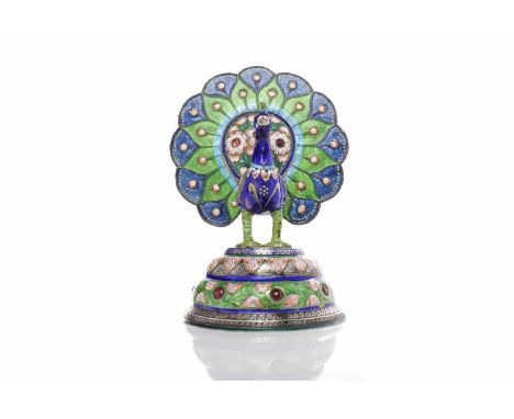 EARLY/MID 20TH CENTURY INDIAN WHITE METAL AND ENAMEL PEACOCK richly decorated in coloured enamels and with jewels, with flora