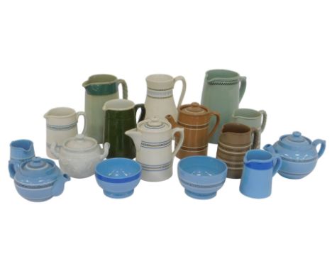 An assortment of Dudson Brothers and other earthenware jugs, in brown, green, blue and cream, including bowls and lidded pots