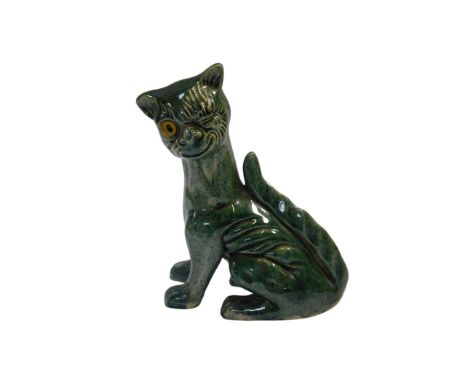 An Aller Vale Devon pottery cat, in green glaze, in winking seated position, impress marks, 16cm high.