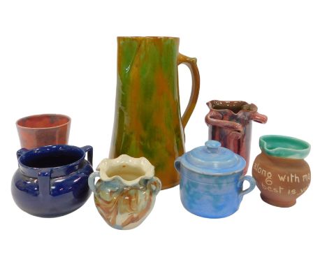 A group of early 20thC Brannam Barnstaple pottery, including jugs, a triple handled vase, a terracotta jug and a tyg, togethe