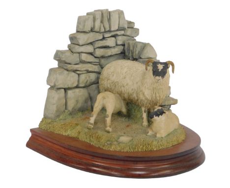 A Border Fine Arts bookend, modelled as a ewe and two lambs, beside a wall, limited edition number 892/1500, initialled AH, o