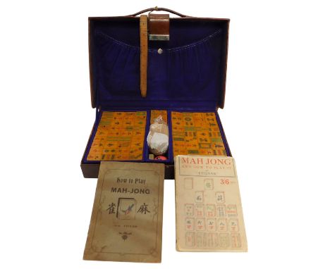 A leather cased Mahjong set, bearing label 'Presented to Captain AO Wilson by Audit Football XI', together with a Mahjong and