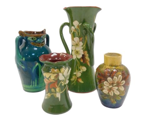 Late 19thC Aller Vale pottery, including a twin-handled character jug with a grotesque mask spout, decorated with reeds, on a