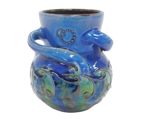 A C H Brannam Barum blue and green glazed vase, of triple scroll handle form, tube line decorated with stylised flowers, poss