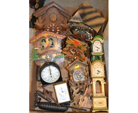 A West German cuckoo clock;others similar; a Smiths cast metal stop clock; a West German miniature novelty long case clock;an