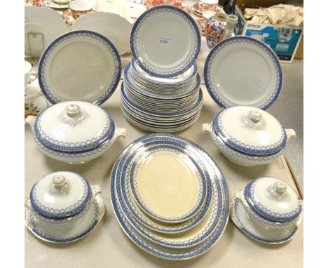 A Staffordshire dinner service, blue border with garlands, comprising vegetable and sauce tureens, graduated service platters