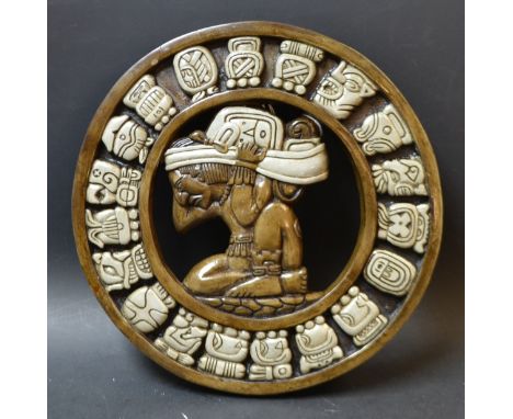 A Mayan calendar disc, Mayan native to centre, year symbols to outer ring.