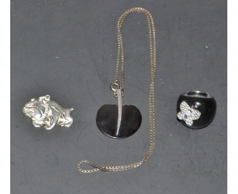 A silver pendant, as a bulldog; a silver and enamel ring; a silver mounted pendant on a neckchain