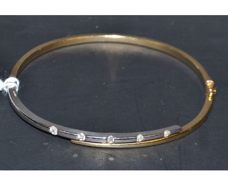 A contemporary diamond hinge bangle, linear set with five individually mounted round brilliant cut diamonds, to the white gol