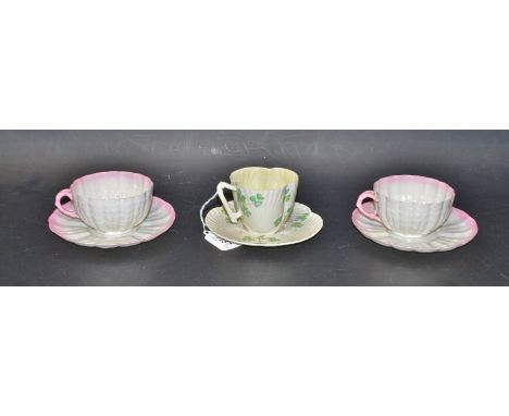 A Belleek clover cup and saucer; another pair (3)