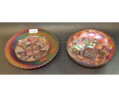 A black and purple carnival glass tripod dish, moulded with fruiting vine; another similar fluted dish moulded with leaves an