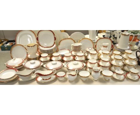 An Aynsley dinner and tea service, applied with bands of red picked out in gilt; Alfred Meakin, Royal Grafton and Myott simil