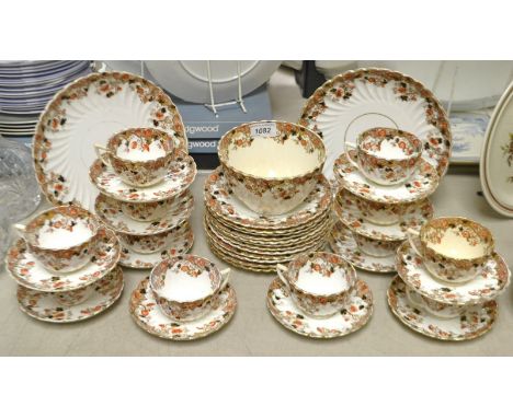 A late 19th century Staffordshire tea service for twelve, comprising bread and butter plates, side plates, slope bowl, cups a