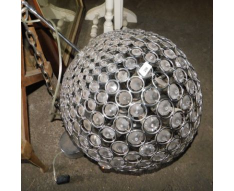 A hanging light fitting, of globular form, inset with various faceted crystals, approx 140cm drop.  Note: VAT is payable on t