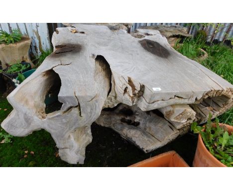 A bleached teak wood sculpture or table, 67cm high, the top 110cm x 110cm. Note: VAT is payable on the hammer price of this l