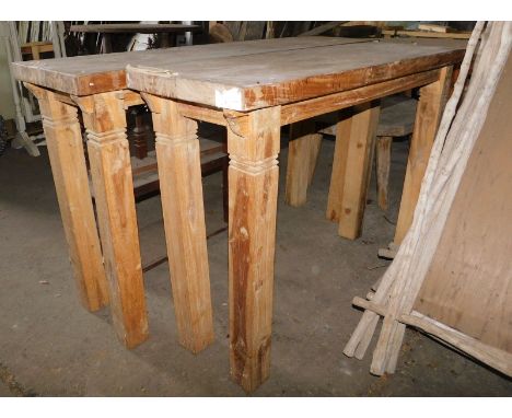 A reclaimed teak console or side table, with a rectangular top raised on strut supports, 85cm high, the top 140cm x 40cm, and