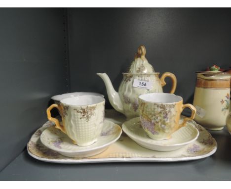 A vintage ceramic tea set with tray and hand decorated floral work 