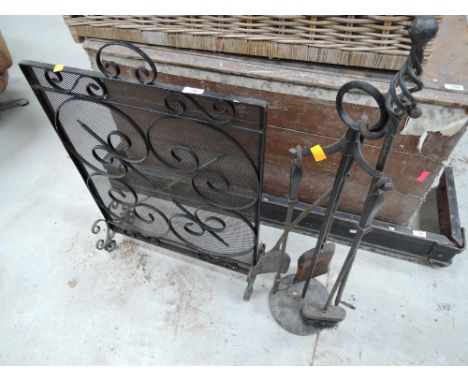 A wrought iron firescreen and companion set